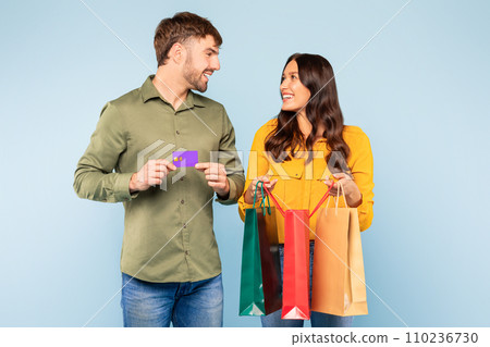 Shopping happy couple with colorful bags and credit card 110236730