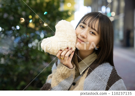 Woman holding white heart outdoors Woman holding white heart outdoors 110237135