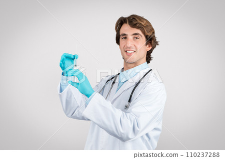 Doctor man preparing syringe for vaccination Doctor man preparing syringe for vaccination 110237288