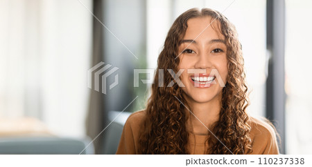 Portrait of caucasian teenage girl with wavy brown hair indoors Portrait of caucasian teenage girl with wavy brown hair indoors 110237338