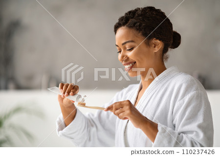 Oral Hygiene. Beautiful Black Woman Applying Toothpaste On Eco Bamboo Toothbrush Oral Hygiene. Beautiful Black Woman Applying Toothpaste On Eco Bamboo Toothbrush 110237426