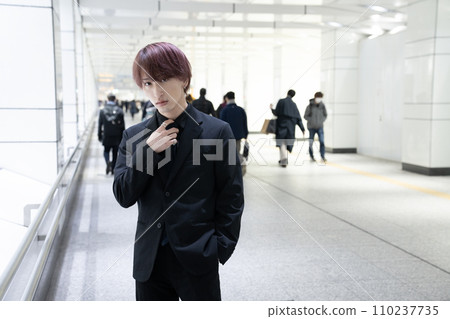 man standing on underground walkway 110237735