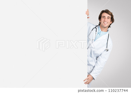 Doctor peeking out from behind a blank banner, mockup Doctor peeking out from behind a blank banner, mockup 110237744
