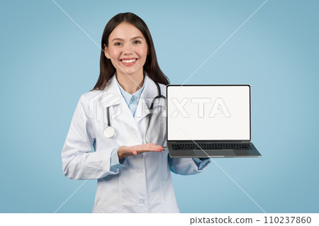 Doctor woman presenting laptop with blank screen Doctor woman presenting laptop with blank screen 110237860