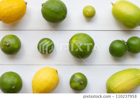 Ripe lemons and limes on white wooden. Ripe lemons and limes on white wooden. 110237958