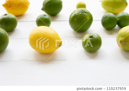 Ripe lemons and limes on white wooden. Ripe lemons and limes on white wooden. 110237959