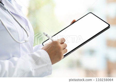 Doctor hands using digital tablet with white screen Doctor hands using digital tablet with white screen 110238064