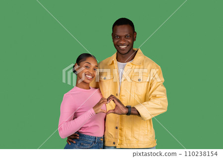 Cute loving african american couple showing heart symbol Cute loving african american couple showing heart symbol 110238154