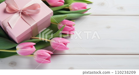 Wonderful spring tulips with gift box on the light pink background. Top view image. Copy space Wonderful spring tulips with gift box on the light pink background. Top view image. Copy space 110238209