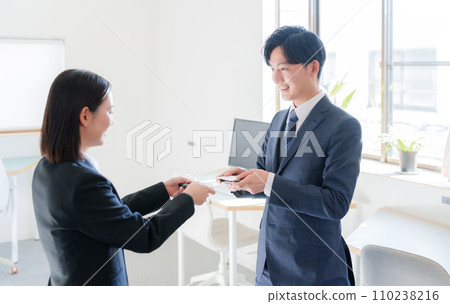 A businessman exchanging business cards A businessman exchanging business cards 110238216