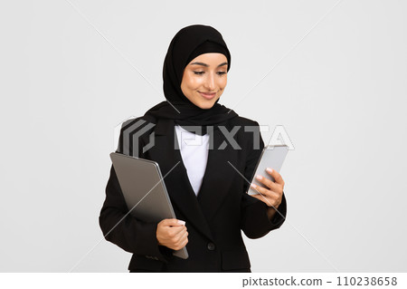 Multitasking businesswoman with tablet and smartphone 110238658