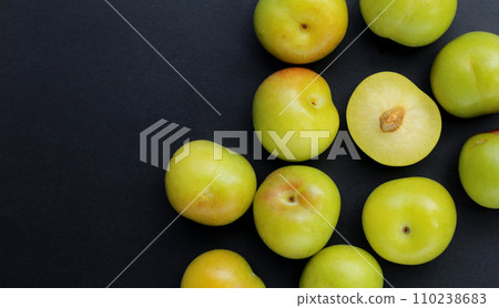 Fresh green plum fruit on dark background. Fresh green plum fruit on dark background. 110238683