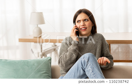 Young irritated hispanic woman arguing with interlocutor via cellphone 110238742