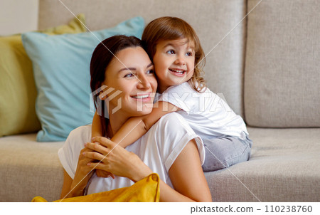 Portrait Of Happy Young Mother And Cute Little Daughter Embracing At Home 110238760