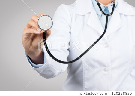 Close-up view of female doctor hand presenting stethoscope, symbolizing health check-ups Close-up view of female doctor hand presenting stethoscope, symbolizing health check-ups 110238859
