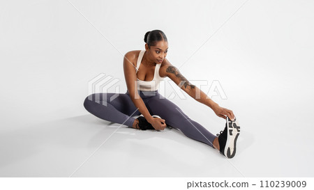 athletic black woman in sportswear has workout in white studio athletic black woman in sportswear has workout in white studio 110239009
