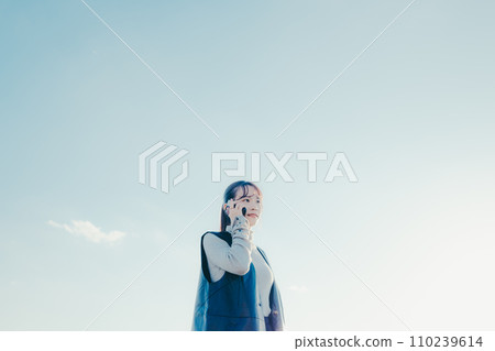 A woman making a phone call 110239614