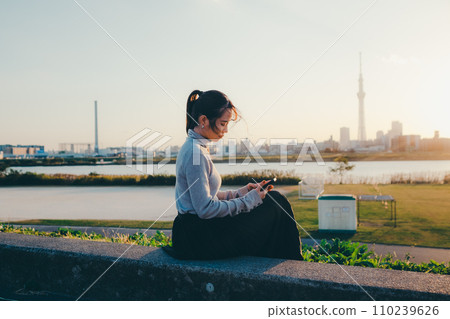A woman making a phone call 110239626