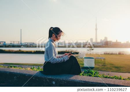 A woman making a phone call 110239627