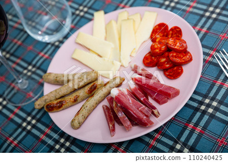 Sliced dry-cured pork loin, sausages and cheese Sliced dry-cured pork loin, sausages and cheese 110240425