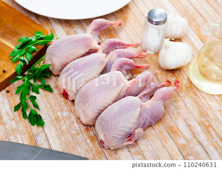 Fresh raw meat quails ready for cooking on slate board 110240631