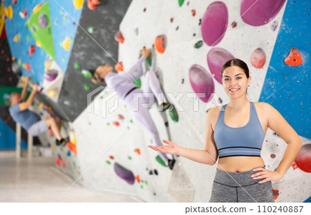 Young woman posing on climbing wall Young woman posing on climbing wall 110240887
