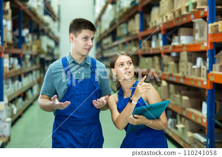 Confident two workers taking inventory of goods in building materials store 110241058