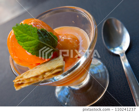 Homemade orange ice cream with wafer and mint on glass cup 110241237