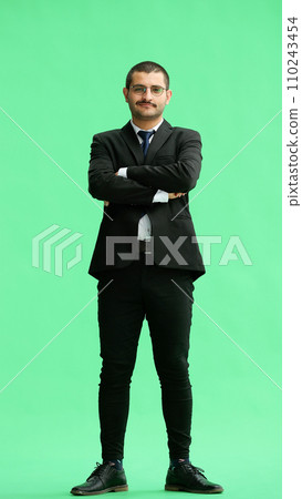 full-length portrait of a young man. standing isolated on green background full-length portrait of a young man. standing isolated on green background 110243454