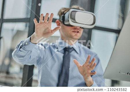 businessman in virtual reality headset in the office 110243582