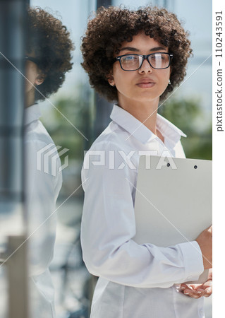 Smiling confident business leader looking at camera and standing in an office 110243591
