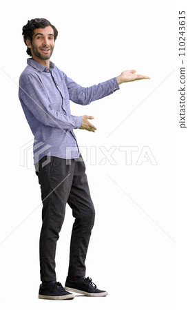 young man in full growth. isolated on white background demonstrates with hands 110243615