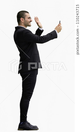 man in full growth. isolated on white background using phone 110243715
