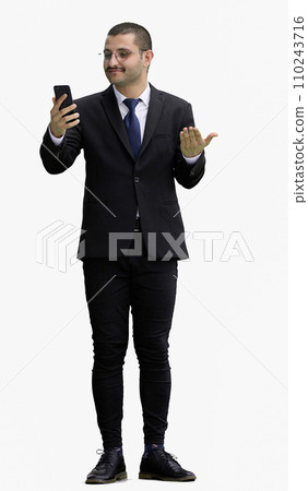 man in full growth. isolated on white background using phone 110243716