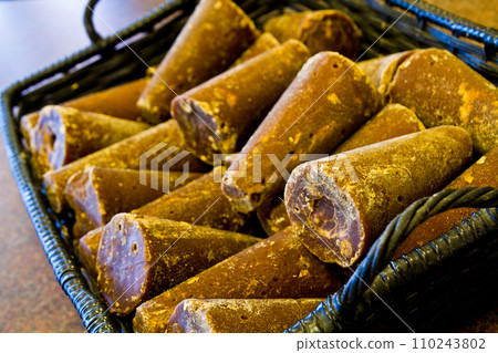 Traditional Palm Sugar in Rustic Basket, Elevated Perspective Close-Up 110243802