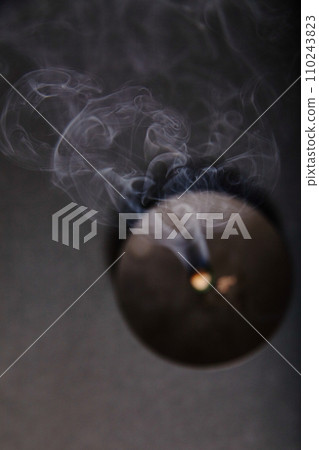 Ethereal Smoke Dance from Extinguished Candle in Tranquil Dim Light 110243823