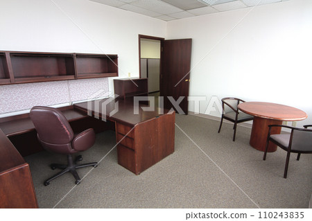 Traditional Empty Office Space with L-Shaped Desk and Meeting Table 110243835
