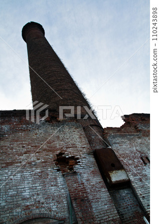 Abandoned Industrial Brick Chimney Overgrown with Vines in Louisville 110243898