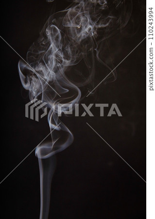 Ethereal Incense Smoke Swirls Against Dark Background Ethereal Incense Smoke Swirls Against Dark Background 110243994