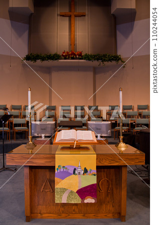 Spiritual Serenity: Pulpit View in Tranquil Church with Wooden Cross and Open Bible Spiritual Serenity: Pulpit View in Tranquil Church with Wooden Cross and Open Bible 110244054