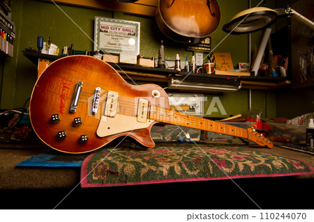 Intimate Glimpse into a Musician's Personal Studio with Vintage Guitar and Memorabilia 110244070
