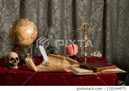 Victorian Study with Skull, Antique Globe, and Scholarly Artifacts and brain on scale with rocks 110244075