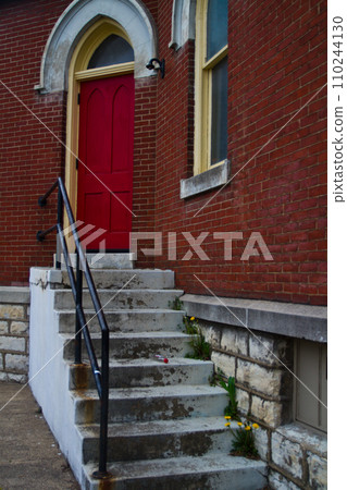 Vintage Red Door Entrance on Brick Building with Dirty White Stairs Vintage Red Door Entrance on Brick Building with Dirty White Stairs 110244130