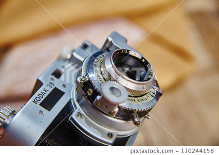 Detail of Vintage Kodak 35 Film Camera on Wooden Surface Close-Up 110244158