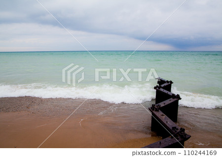Overcast Day at Lake Michigan with Weathered Pier Remnants Overcast Day at Lake Michigan with Weathered Pier Remnants 110244169