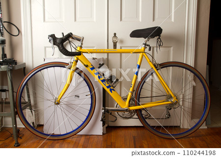 Yellow Bicycle with water bottle in Apartment Ready for a Ride 110244198