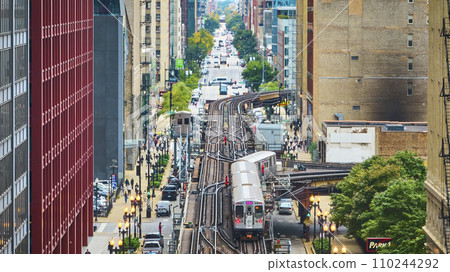 Train on railroad in big, inner city aerial of Chicago tourism transit and travel on summer day 110244292