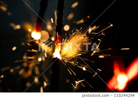 Vibrant Sparklers Igniting in Night Celebration Close-Up 110244294