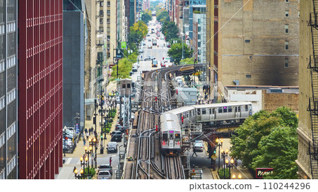 Train on tracks in Chicago aerial of big, inner city transit, travel and tourism with buildings Train on tracks in Chicago aerial of big, inner city transit, travel and tourism with buildings 110244296