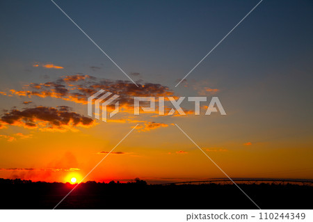 Fiery Sunset Over Silhouetted Landscape in Empire, Michigan Fiery Sunset Over Silhouetted Landscape in Empire, Michigan 110244349